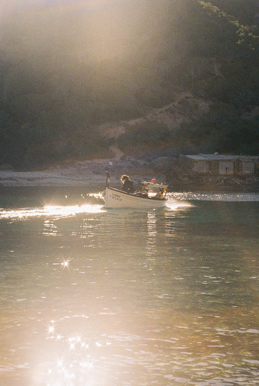 Fotografía analógica Domingo IV en Ibiza por Sofía Gómez-Fonzo, barco saliendo de cala pesquera del norte